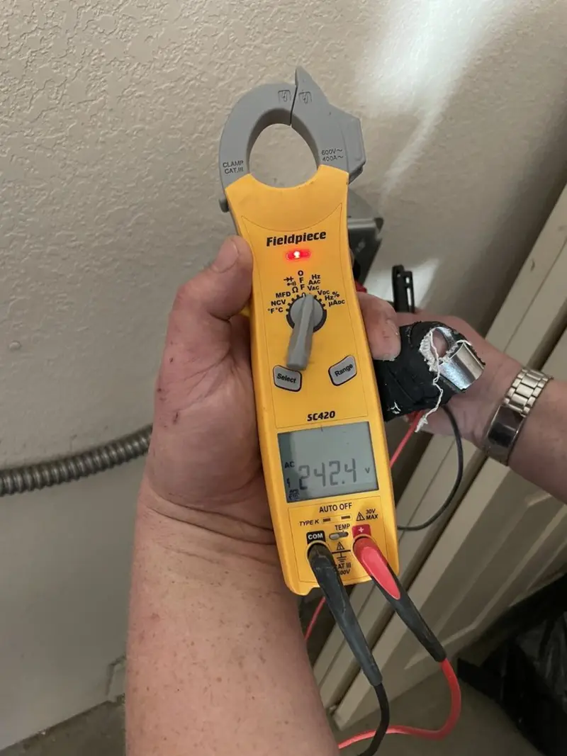 Voltage testing with clamp meter during Ceiling Fan Installation in Thomas